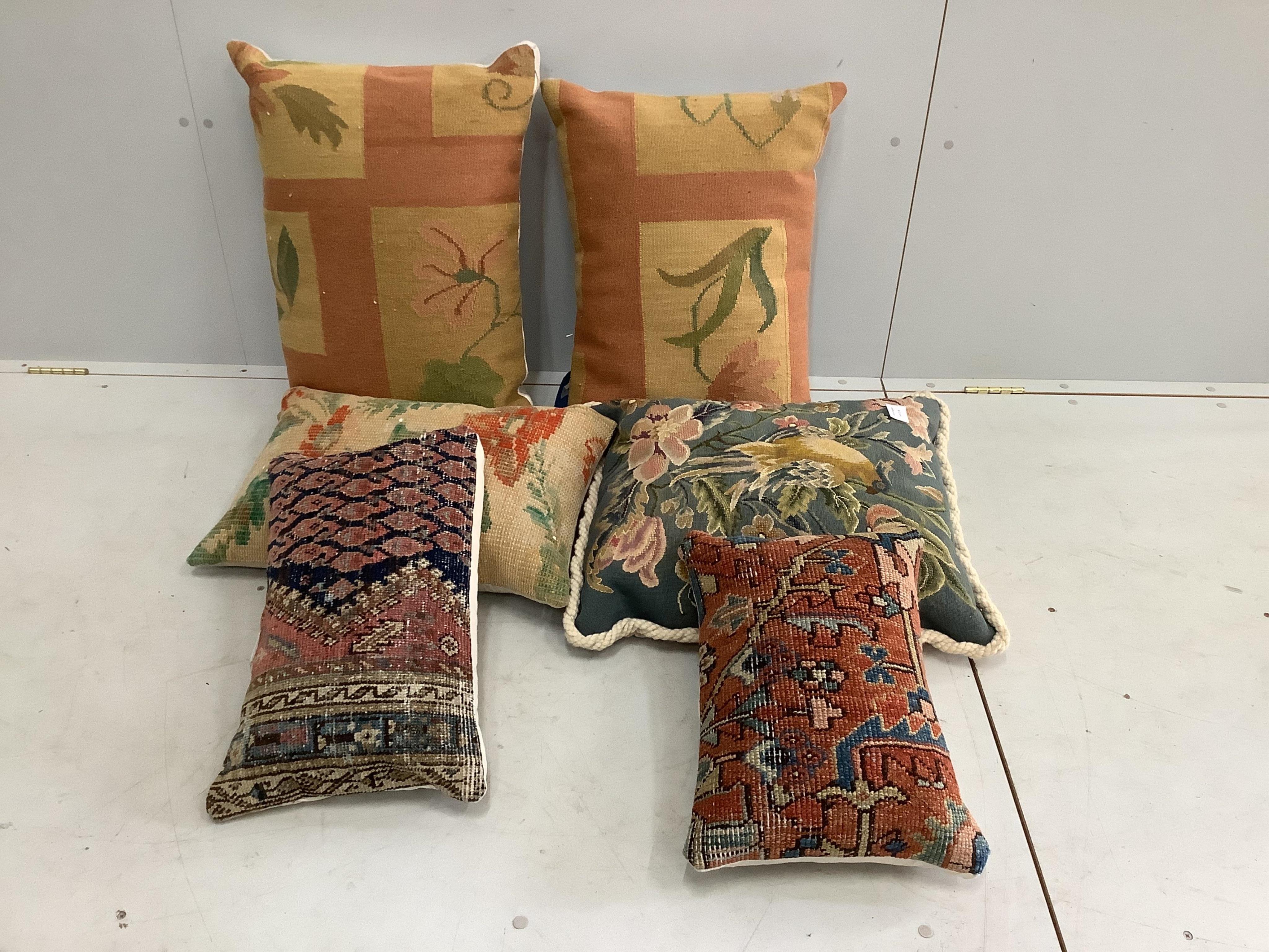 Six various tapestry and rug fabric covered cushions, largest 64 x 46cm. Condition - good